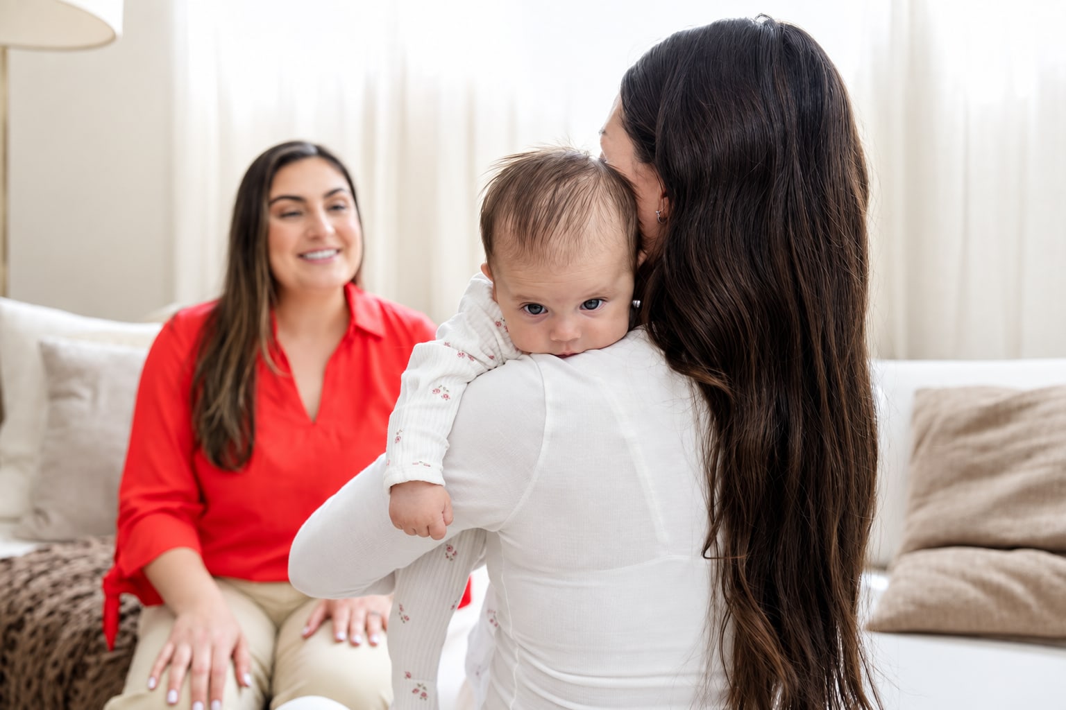 A mother kissing her baby, Bruna by her side